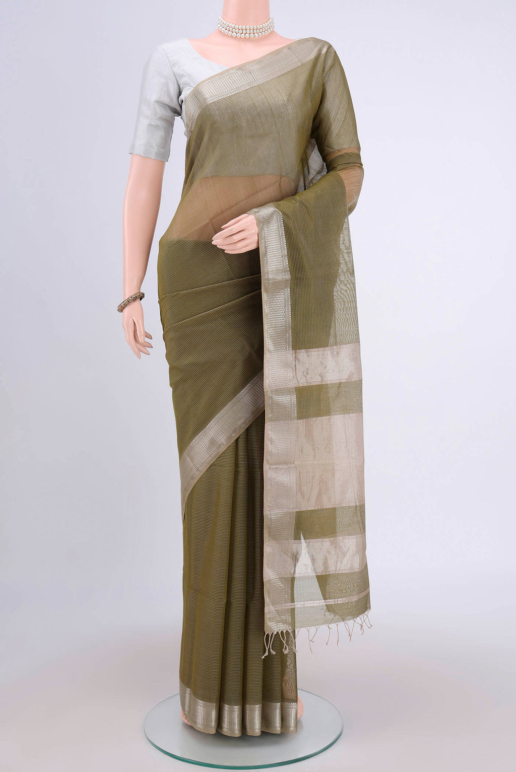 Mehandi Green Maheshwari Silk Cotton Saree with Stripes on the body and Zari Border.  displayed on a mannequin