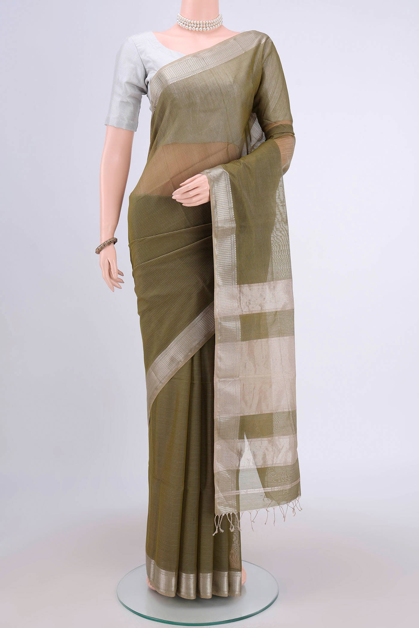 Mehandi Green Maheshwari Silk Cotton Saree with Stripes on the body and Zari Border.  displayed on a mannequin