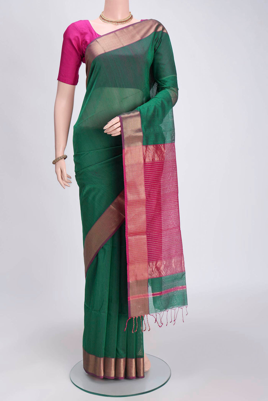 Green Maheshwari Silk Cotton Saree with Zari Butta on the body and Zari Border.  displayed on a mannequin