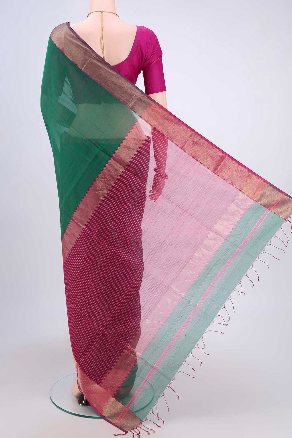 Flat view of Green Maheshwari Silk Cotton Saree with Zari Butta on the body and Zari Border. 