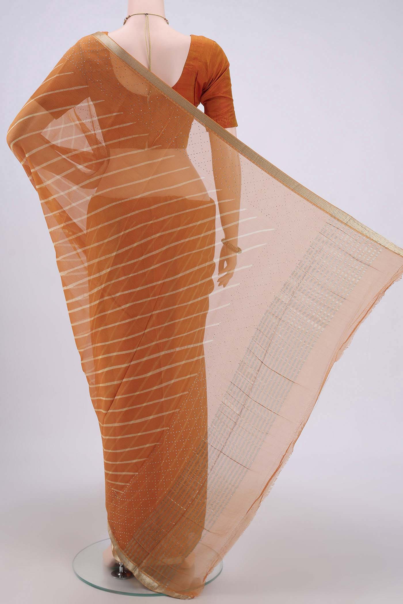 Flat view of Brick Orange Mysore Chiffon Saree with Printed design on the body and Zari Border. 