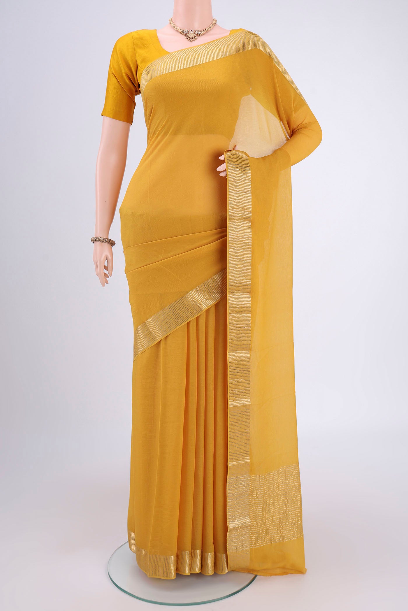 Yellow Mysore Chiffon Saree with Plain Body and Zari Border.  displayed on a mannequin