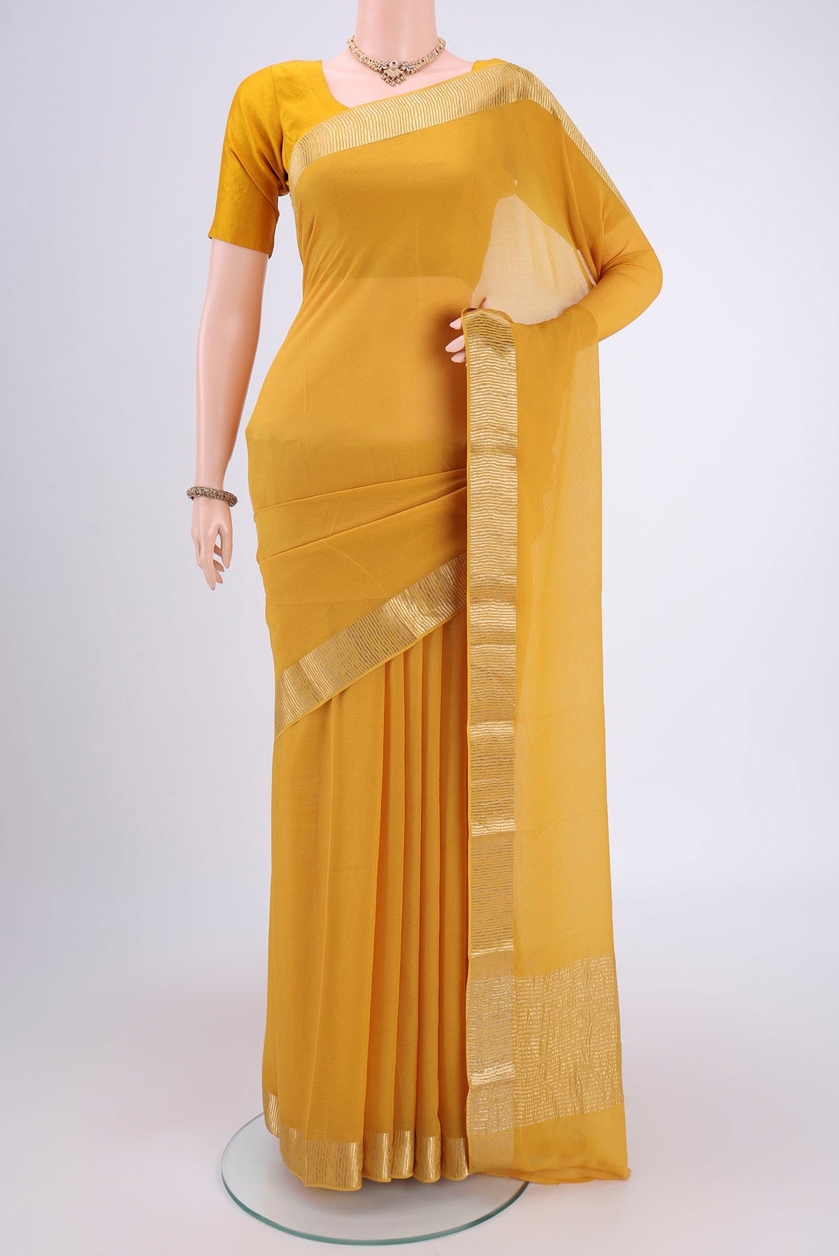 Yellow Mysore Chiffon Saree with Plain Body and Zari Border.  displayed on a mannequin