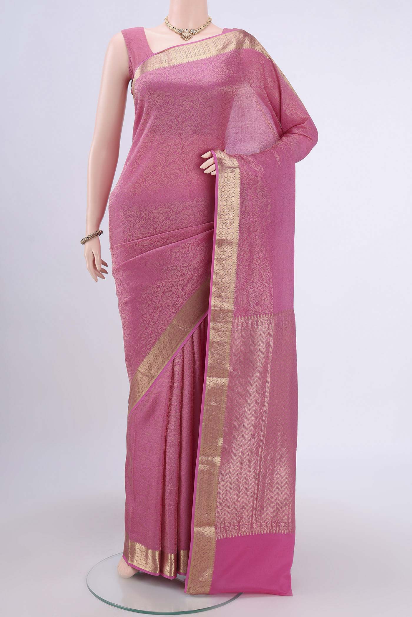 Rani Pink Mysore Crepe Saree with Zari Brocade on the body and Zari Border.  displayed on a mannequin