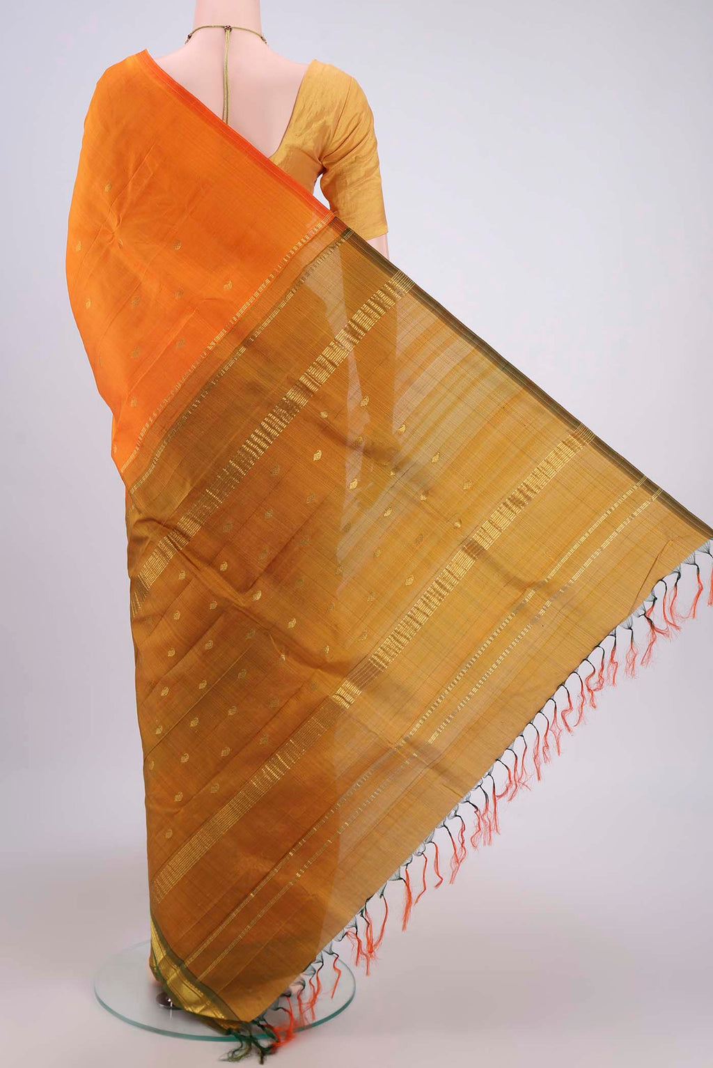 Flat view of Orange Kanjivaram Silk Saree with Zari Butta on the body and One Side Border. 