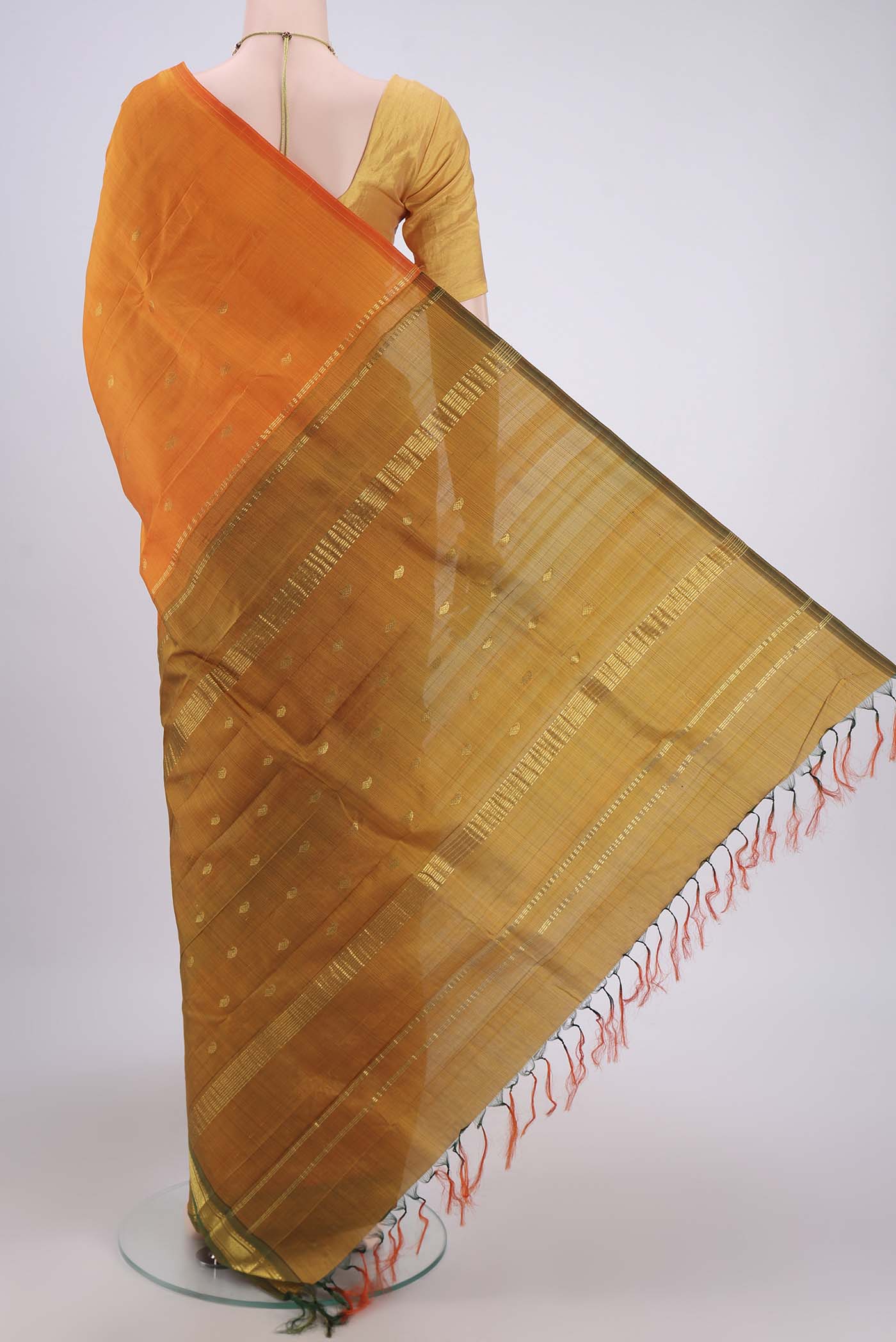 Flat view of Orange Kanjivaram Silk Saree with Zari Butta on the body and One Side Border. 