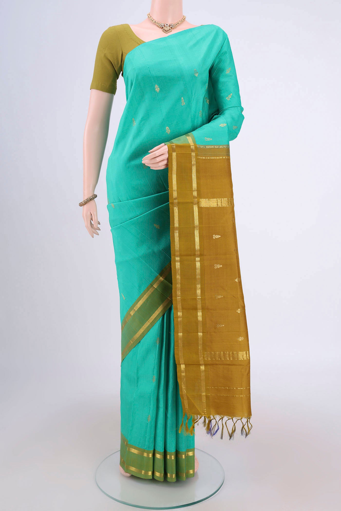 Turquoise Dual Tone Kanjivaram Silk Saree with Zari Butta on the body and Zari Border.  displayed on a mannequin
