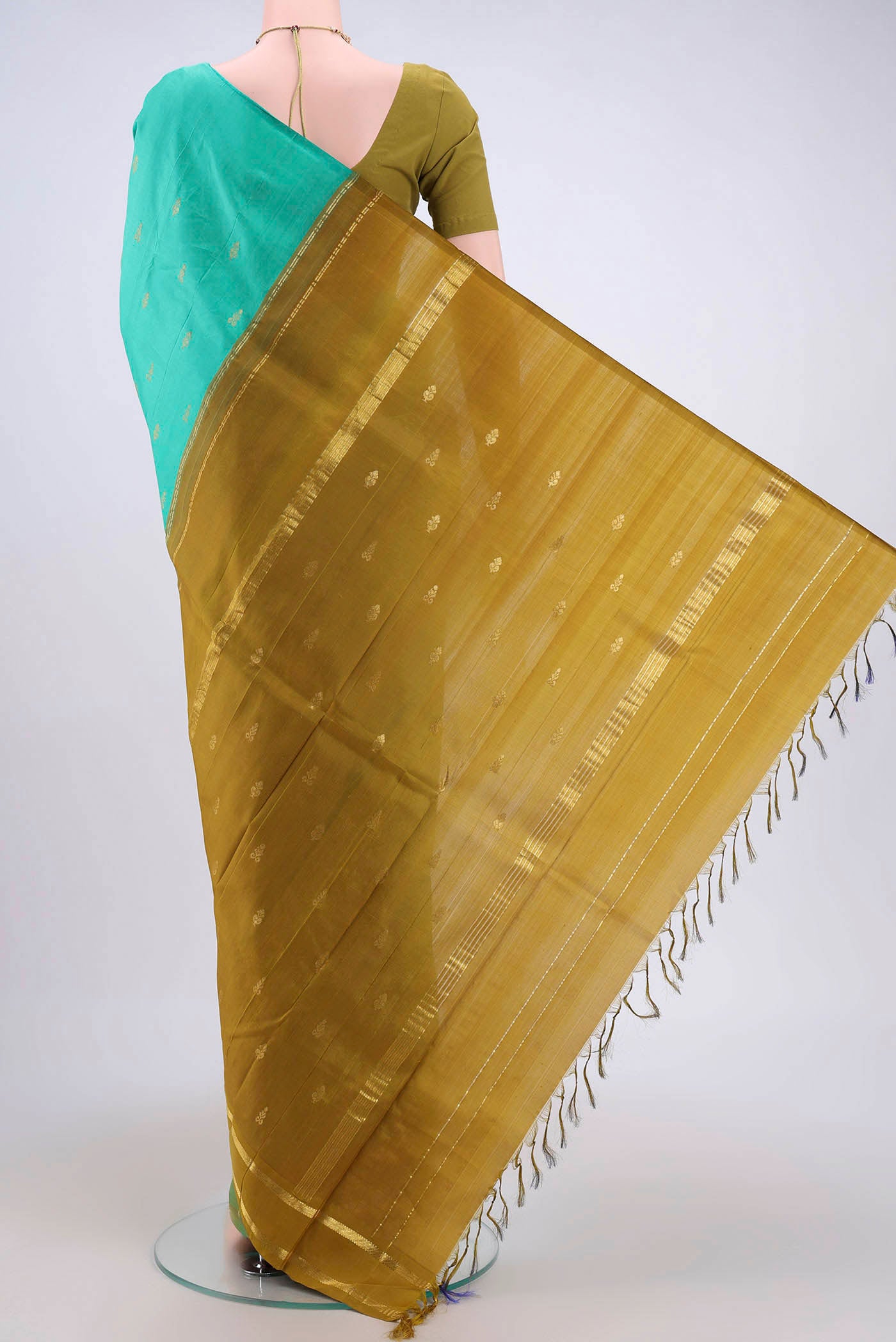 Flat view of Turquoise Dual Tone Kanjivaram Silk Saree with Zari Butta on the body and Zari Border. 