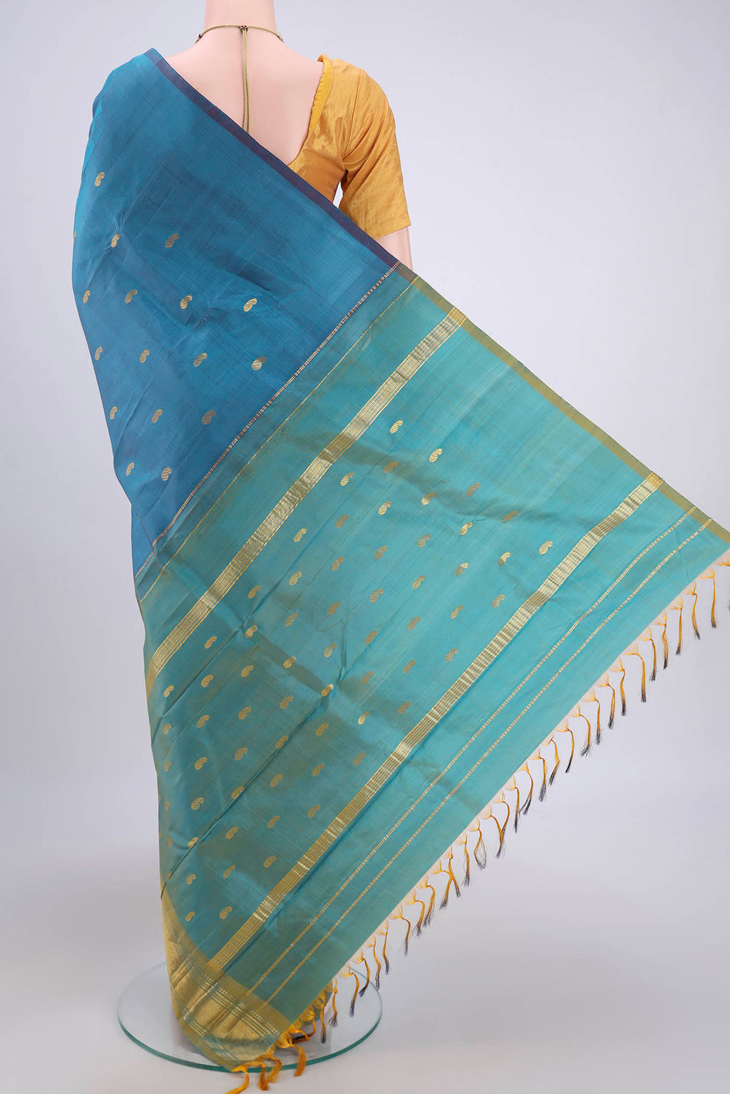 Flat view of Light Blue Kanjivaram Silk Saree with Zari Butta on the body and One Side Border. 
