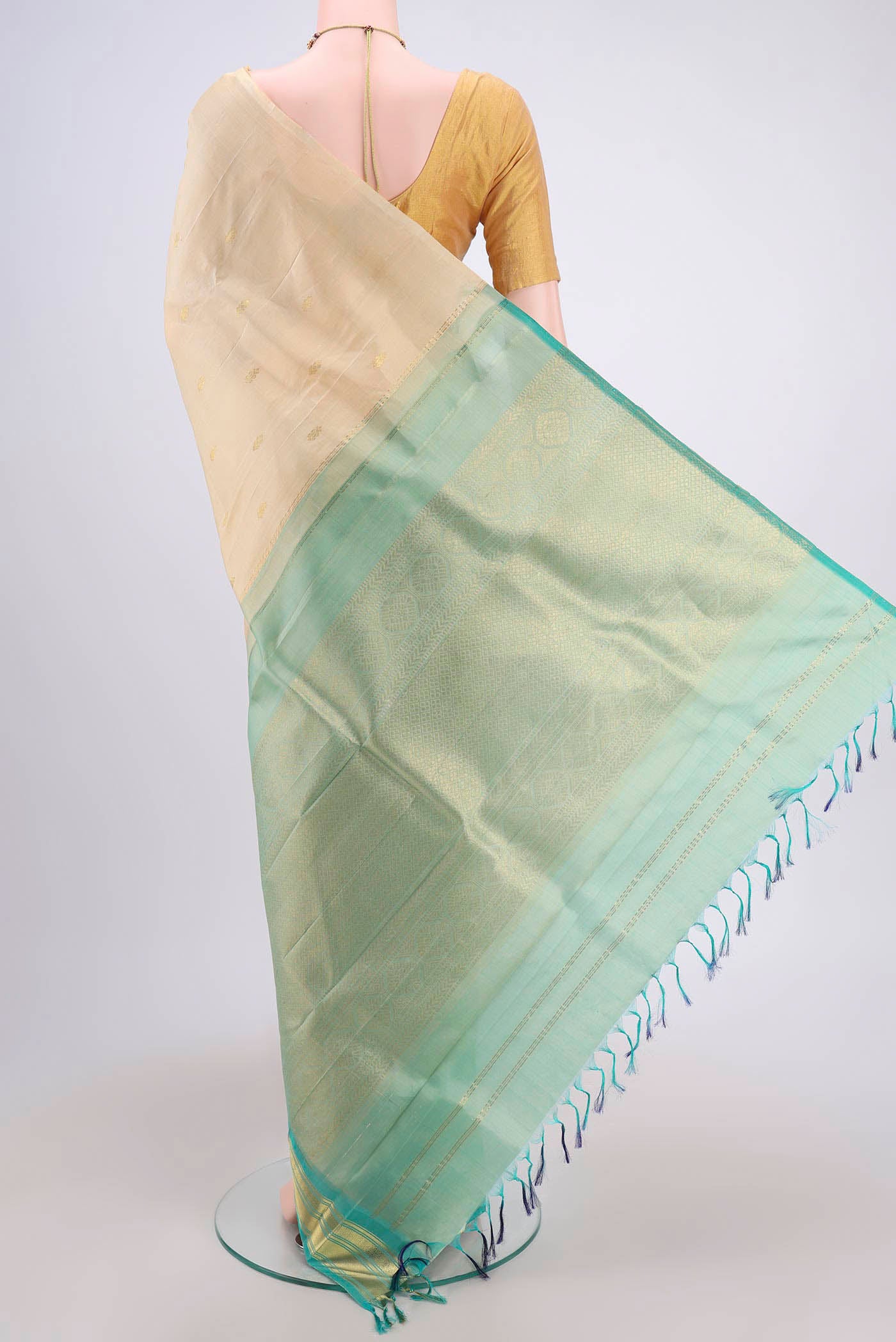 Flat view of Cream Dual Tone Kanjivaram Silk Saree with Zari Butta on the body and One Side Border. 