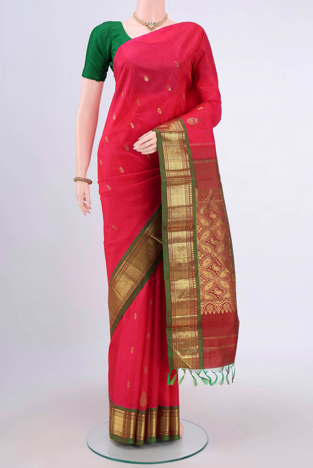 Dark Pink Kanjivaram Silk Saree with Zari Butta on the body and One Side Border.  displayed on a mannequin