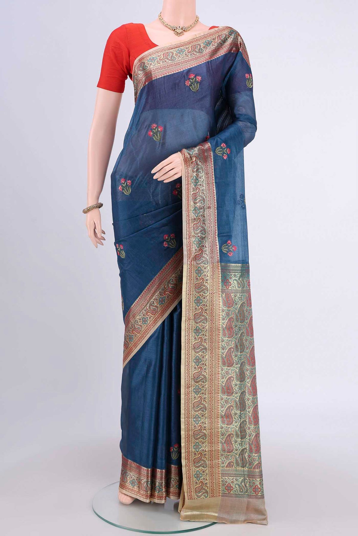 Blue Banarasi Raw Silk Saree with Embroidery on the body and Zari Border.  displayed on a mannequin