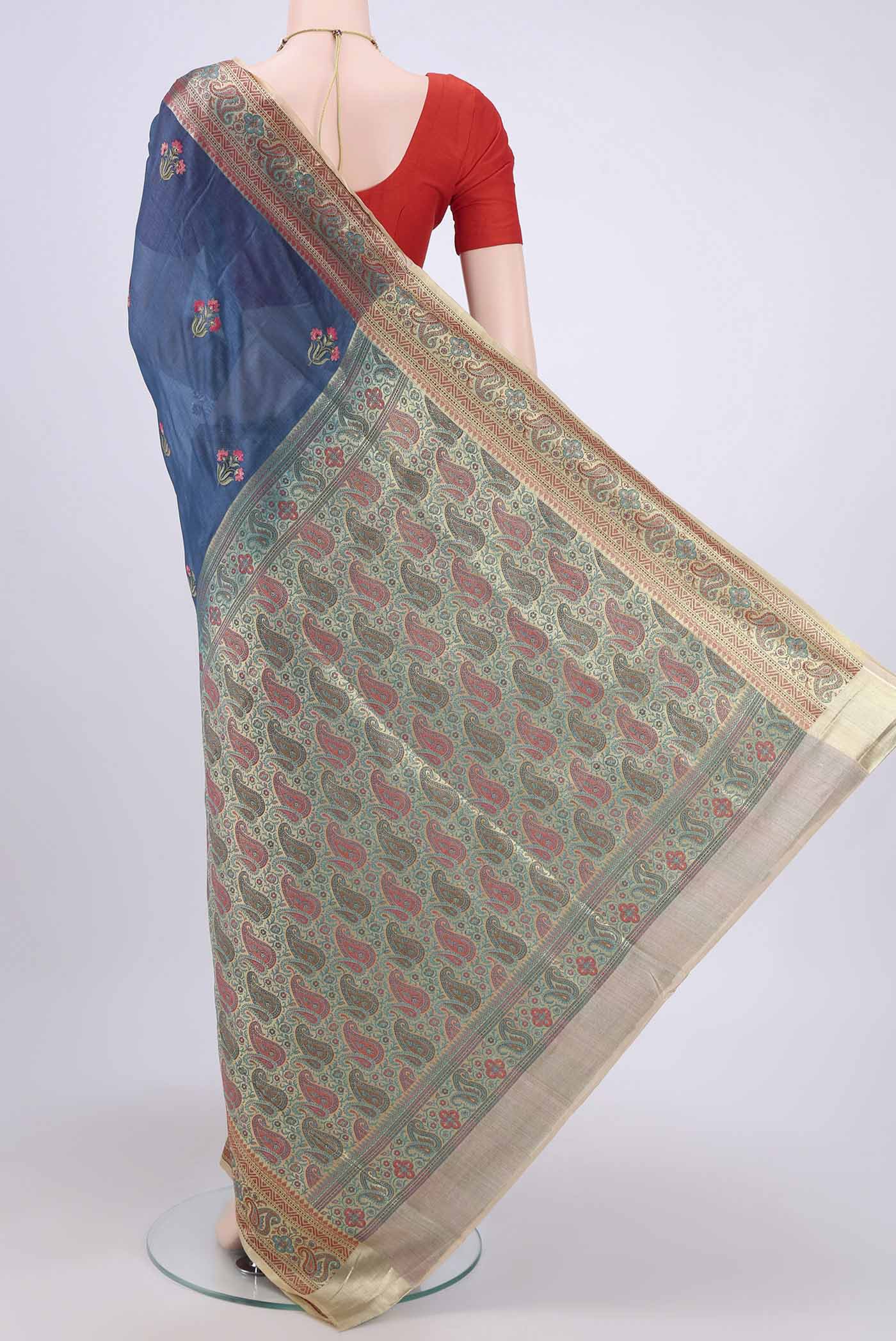 Flat view of Blue Banarasi Raw Silk Saree with Embroidery on the body and Zari Border. 