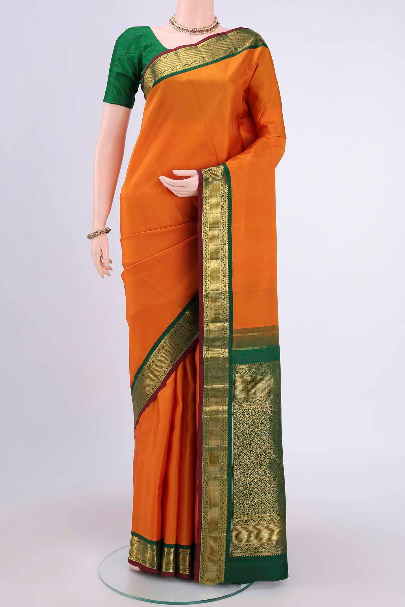 Yellow Kanchipuram Saree with Plain Body and Zari Border.  displayed on a mannequin