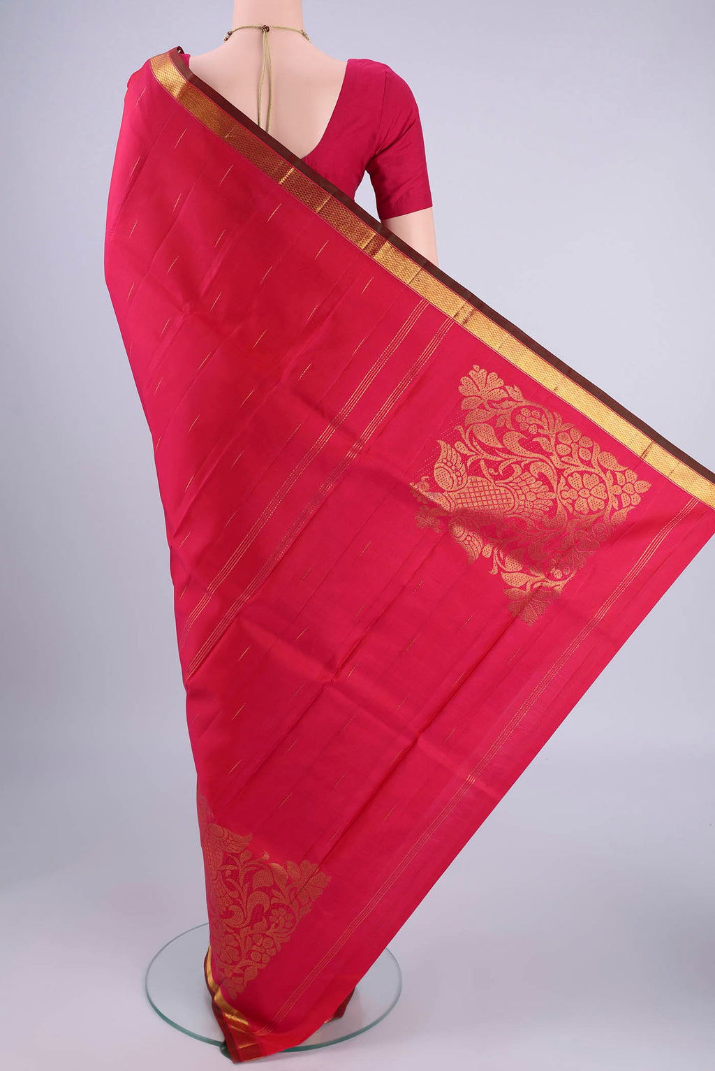 Flat view of Rani Pink Kanjivaram Silk Saree with Zari Butta on the body and Zari Border. 