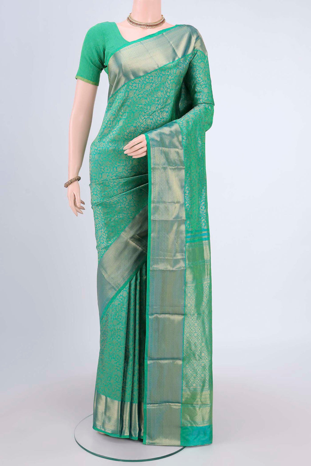 Sea Green Kanchipuram Saree with Zari Brocade on the body and Rising Temple Border.  displayed on a mannequin