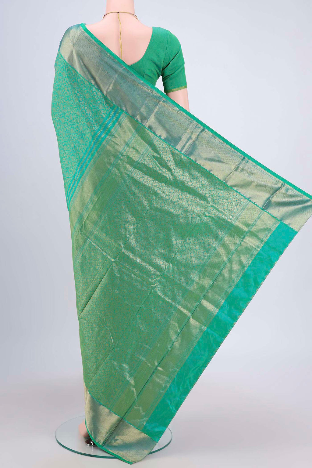 Flat view of Sea Green Kanchipuram Saree with Zari Brocade on the body and Rising Temple Border. 