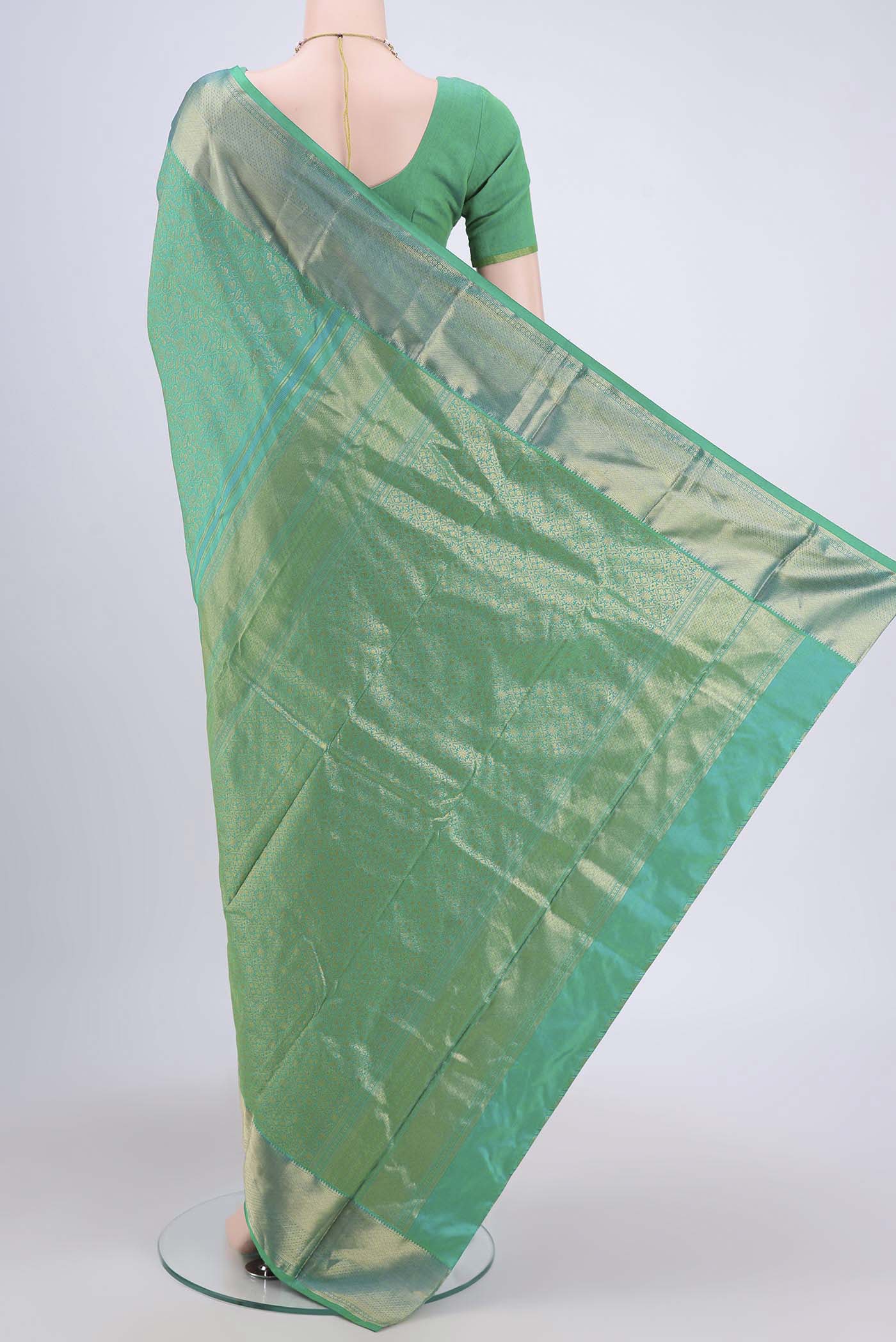 Flat view of Sea Green Kanchipuram Saree with Zari Brocade on the body and Rising Temple Border. 