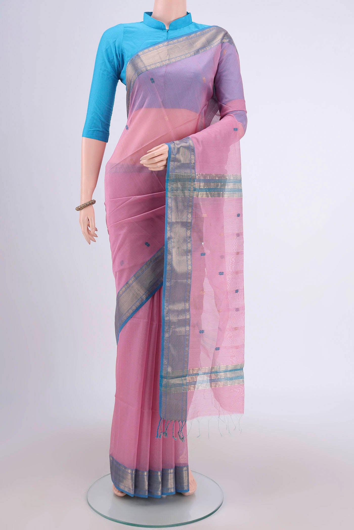 Pink Maheshwari Silk Cotton Saree with Stripes on the body and Zari Border.  displayed on a mannequin
