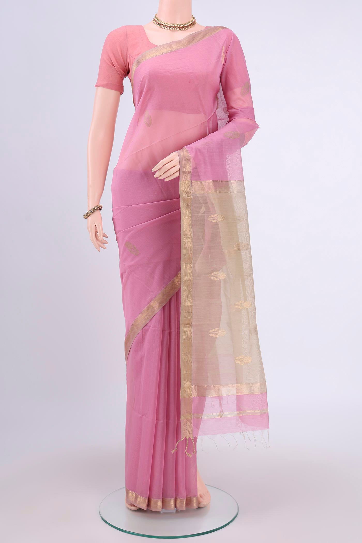 Rose pink Maheshwari Silk Cotton Saree with Zari Butta on the body and Zari Border.  displayed on a mannequin