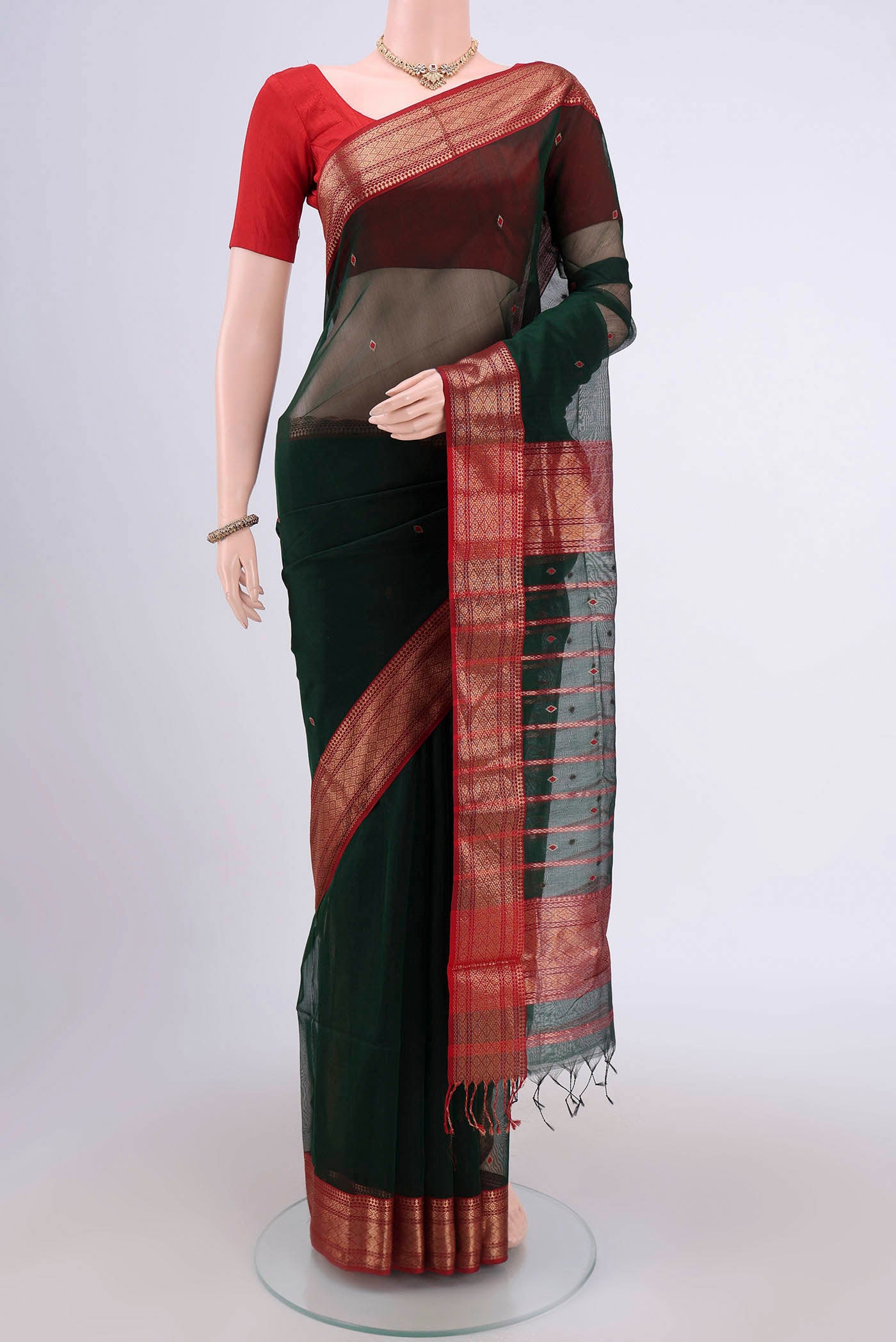 Bottle Green Maheshwari Silk Cotton Saree with Stripes on the body and Zari Border.  displayed on a mannequin