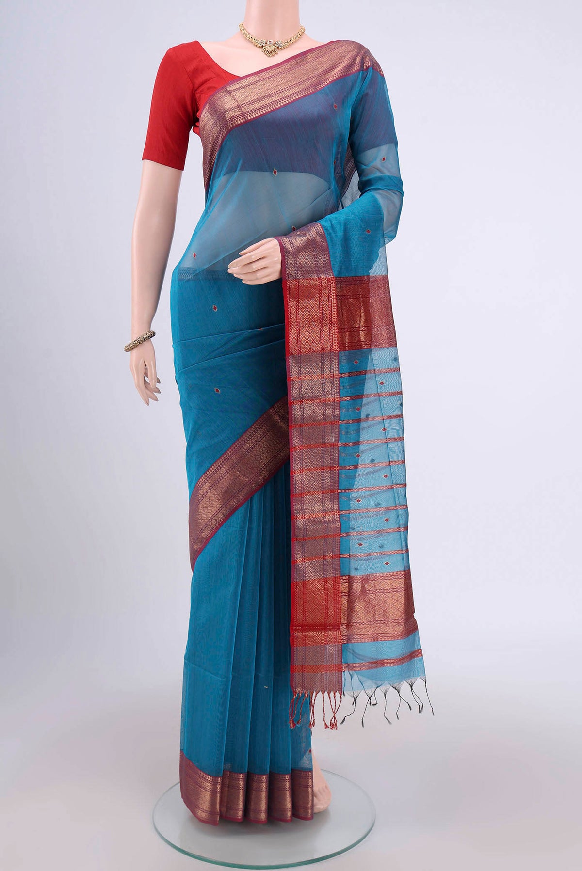 Blue Maheshwari Silk Cotton Saree with Stripes on the body and Zari Border.  displayed on a mannequin