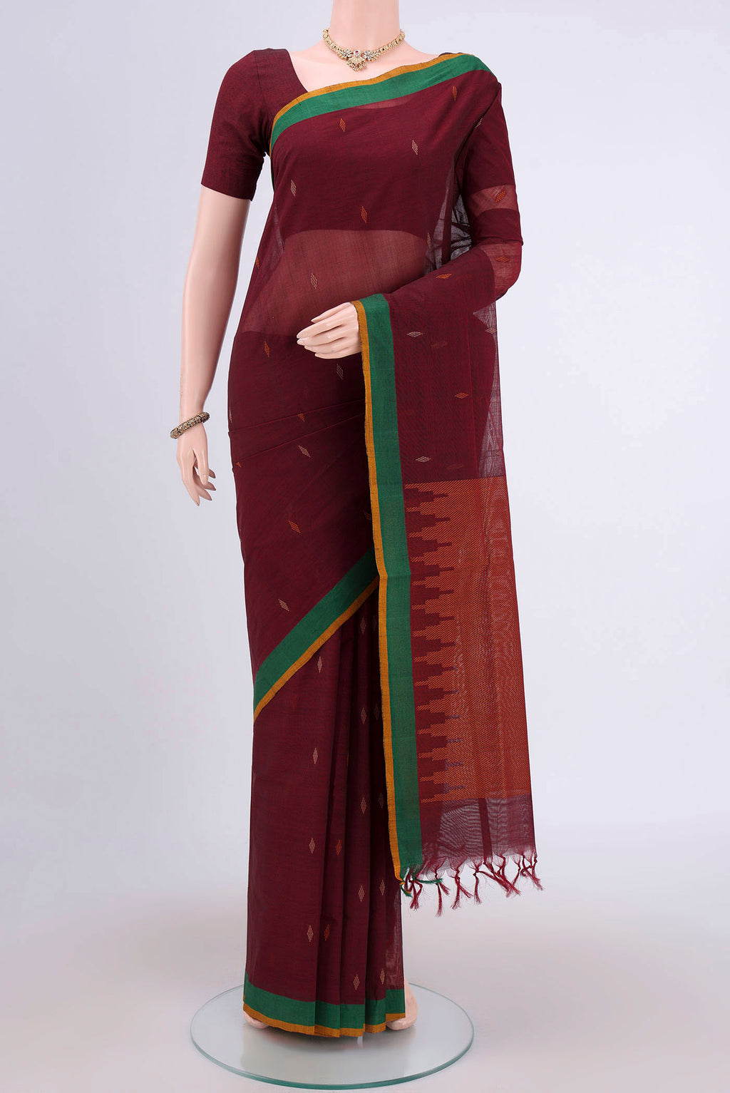Maroon Coimbatore Cotton Saree with Thread Butta on the body and Plain Border.  displayed on a mannequin
