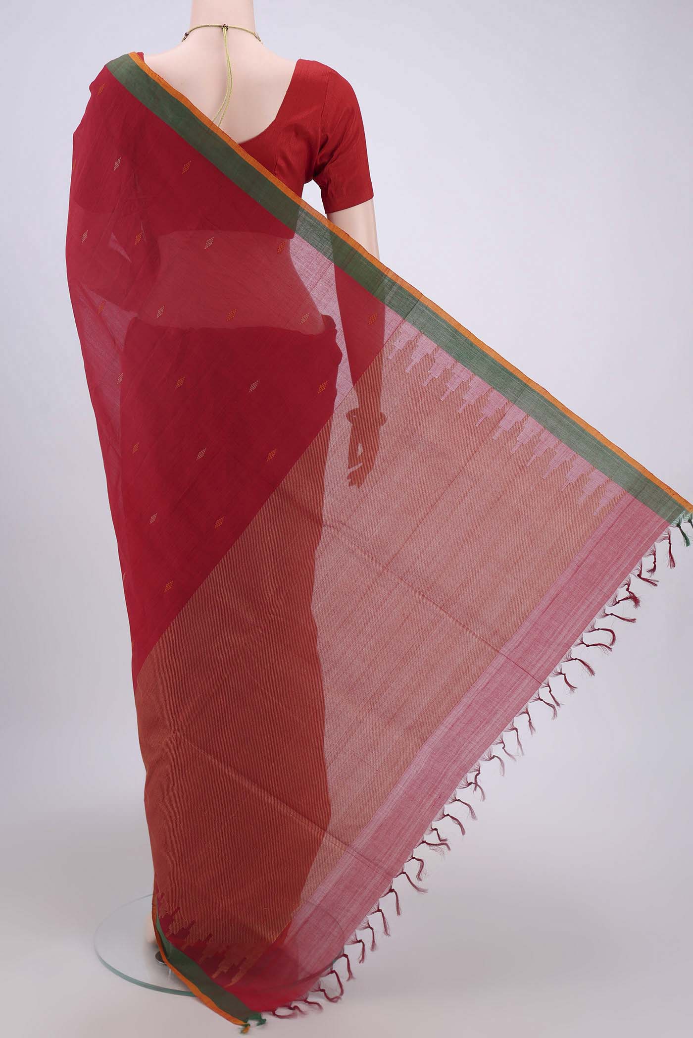 Flat view of Red Coimbatore Cotton Saree with Thread Butta on the body and Zari Border. 