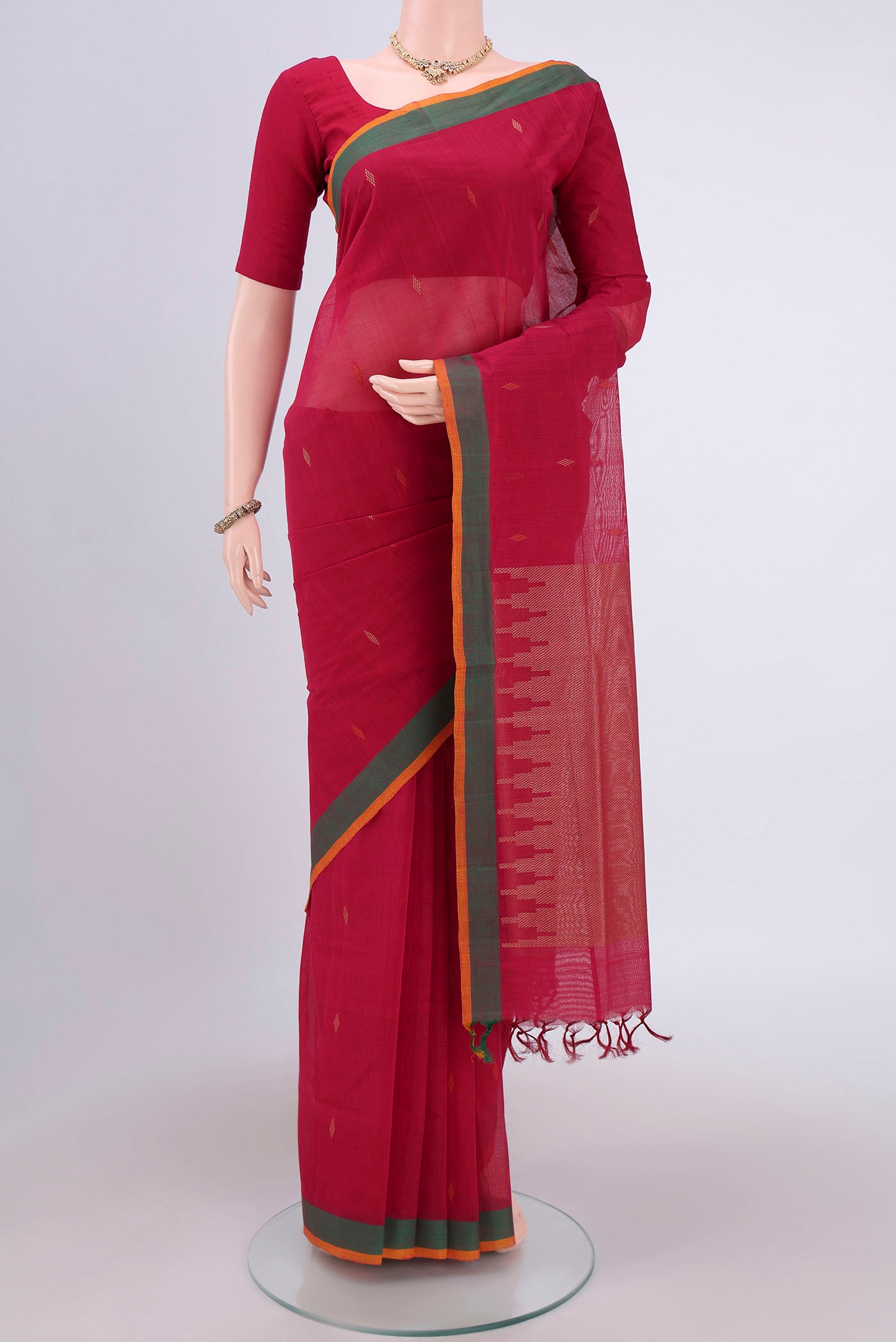 Dark Pink Coimbatore Cotton Saree with Thread Butta on the body and Zari Border.  displayed on a mannequin