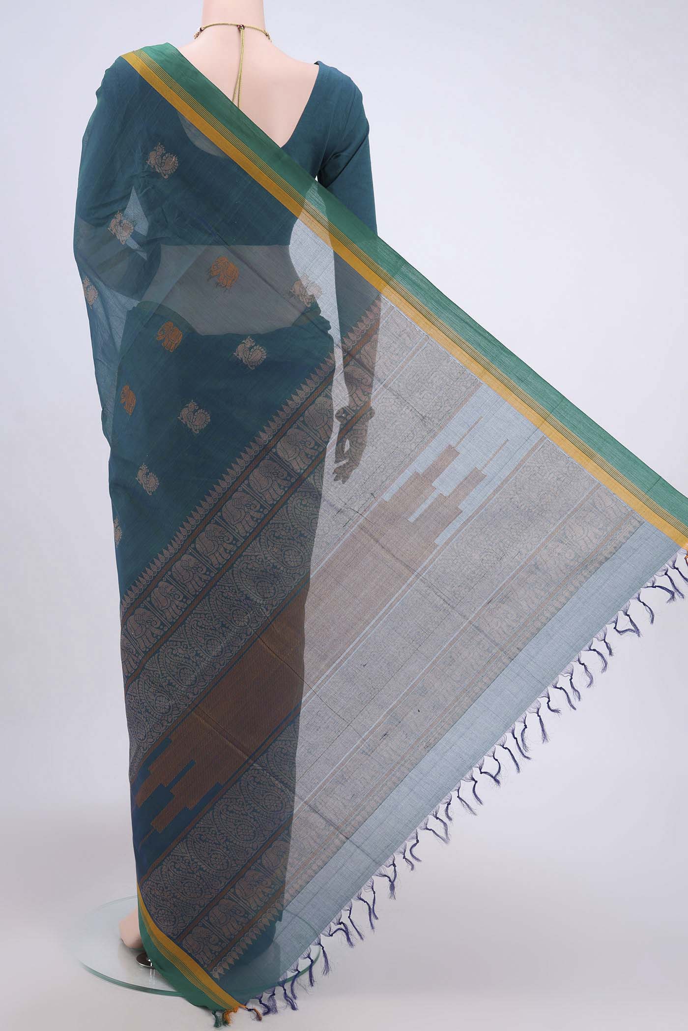 Flat view of Peacock Blue Coimbatore Cotton Saree with Thread Butta on the body and Plain Border. 