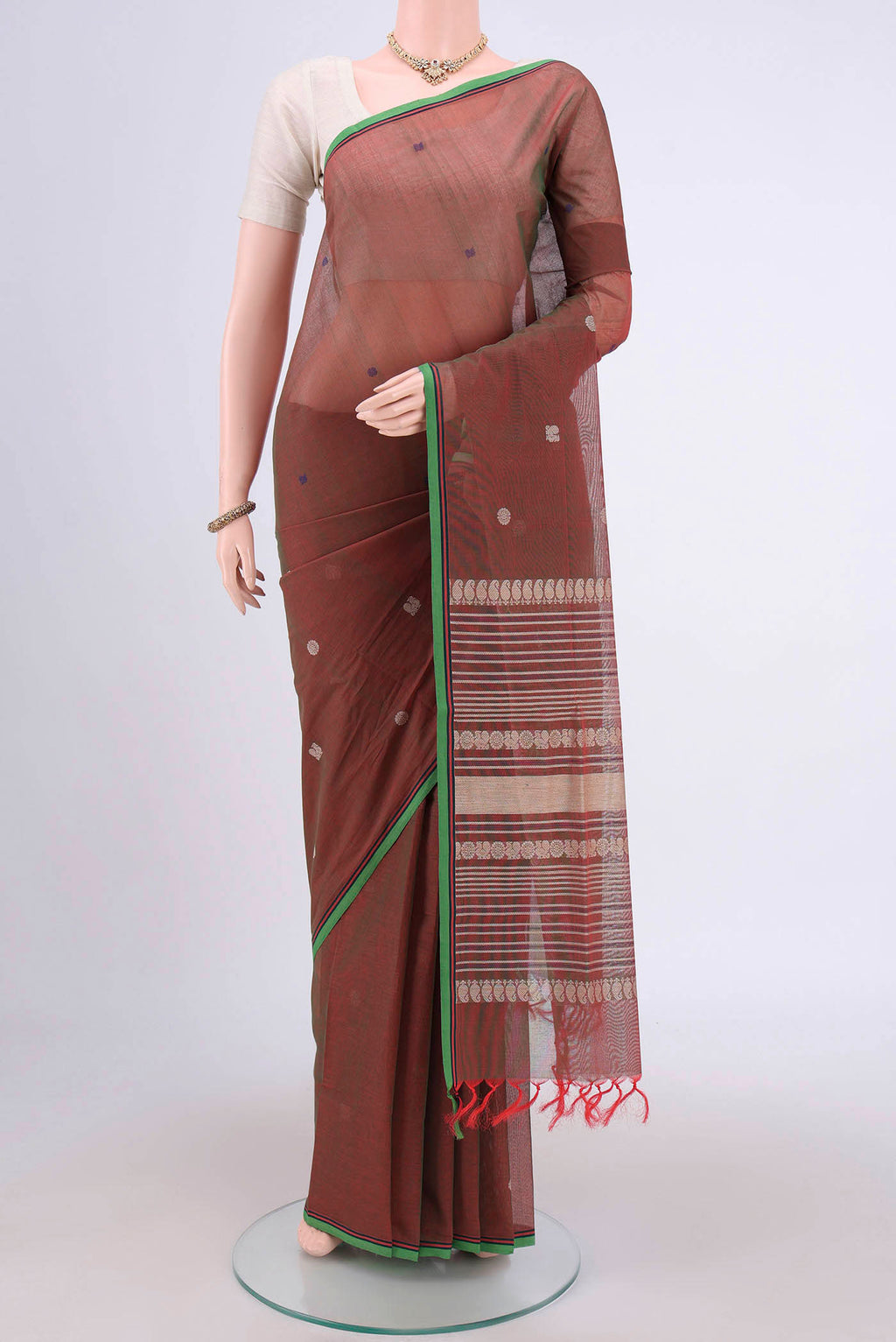 Rust Coimbatore Cotton Saree with Thread Butta on the body and Plain Border.  displayed on a mannequin