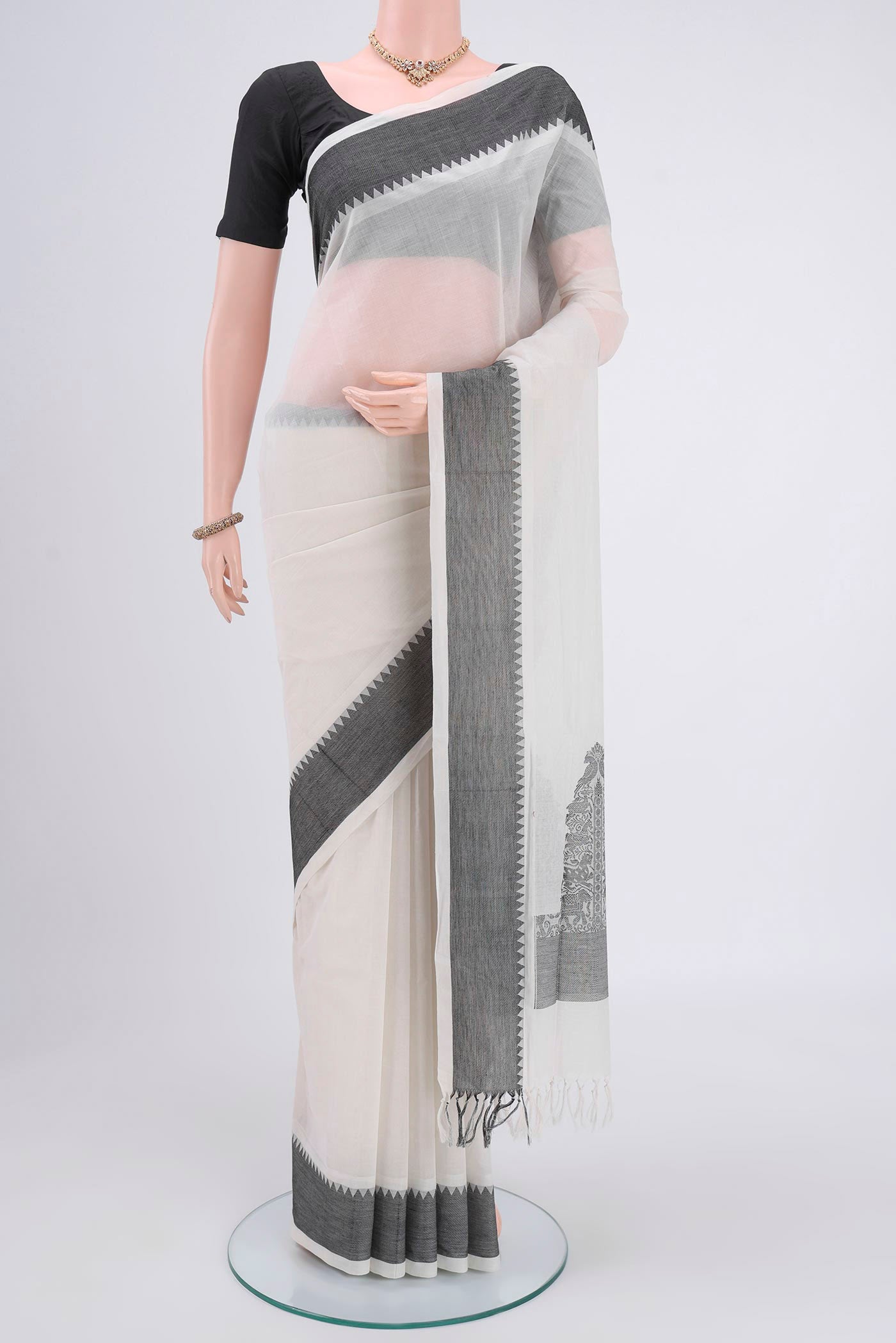 Off White Coimbatore Cotton Saree with Plain Body and Zari Border.  displayed on a mannequin