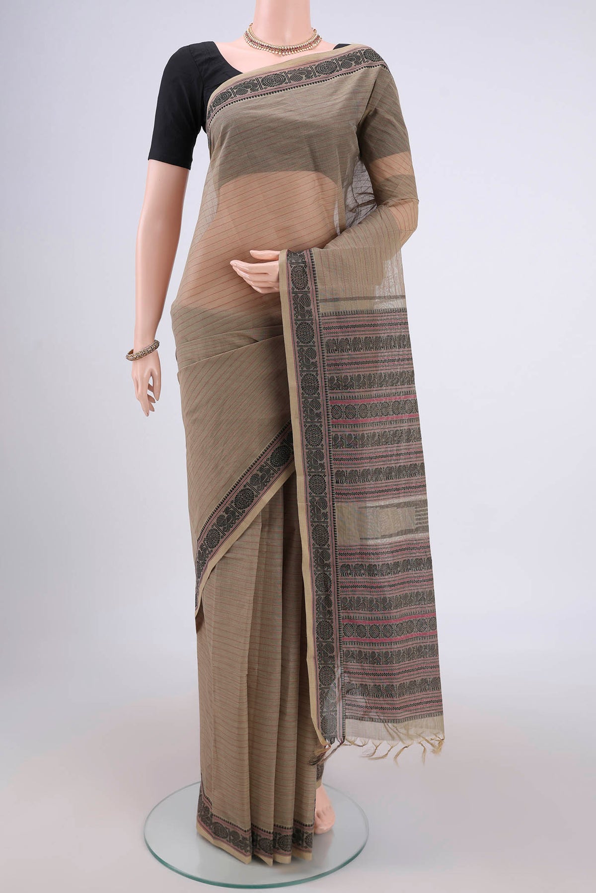 Dark Beige Kanchi Cotton Saree with Stripes on the body and Thread Border.  displayed on a mannequin