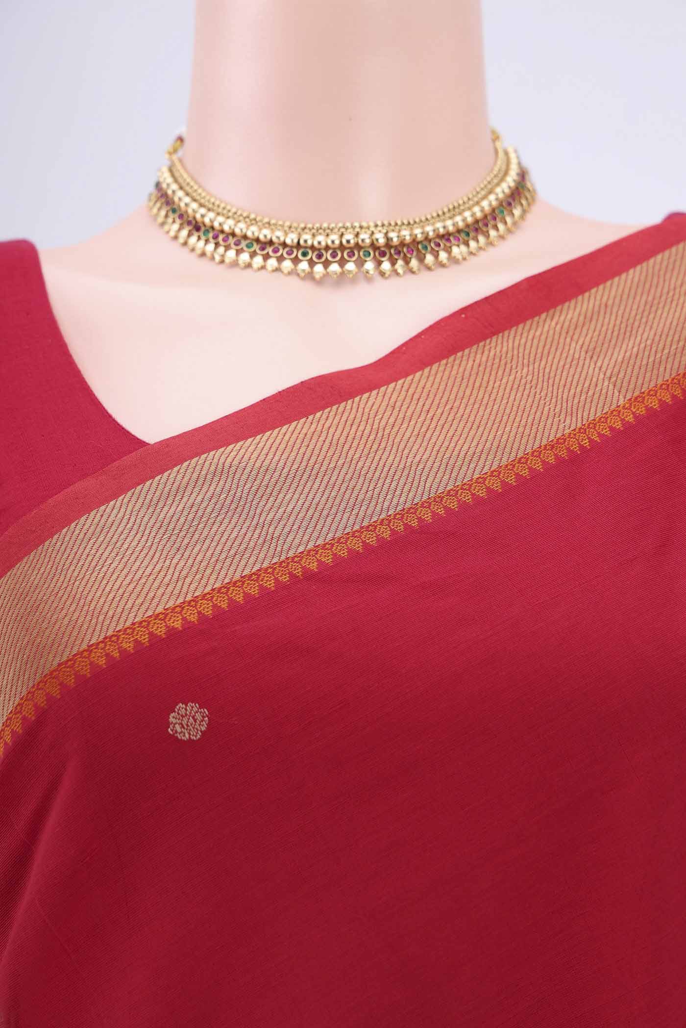 Border image of Red Kanchi Cotton Saree with Thread Butta on the body and Thread Border. 