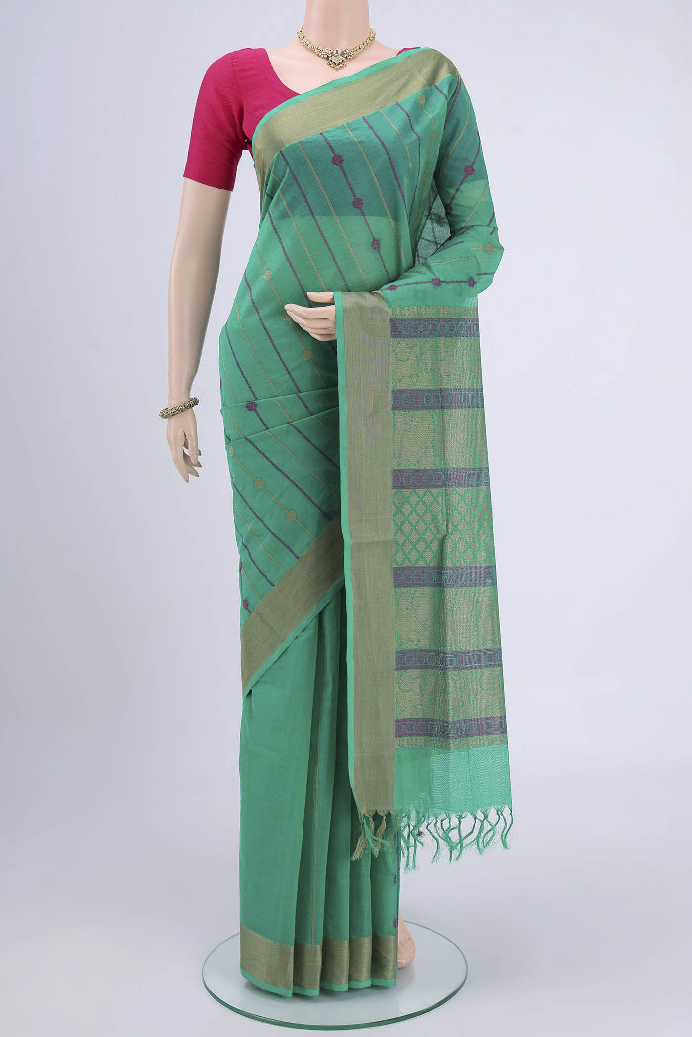 Turquoise Coimbatore Cotton Saree with Stripes on the body and Zari Border.  displayed on a mannequin