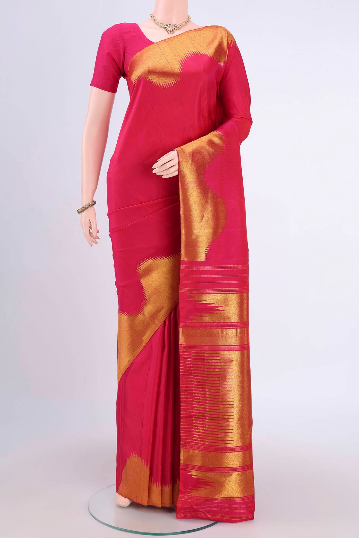 Pure Silk Pure Zari Rani Pink Kanjivaram Saree with Plain Body and Zari Border.  displayed on a mannequin