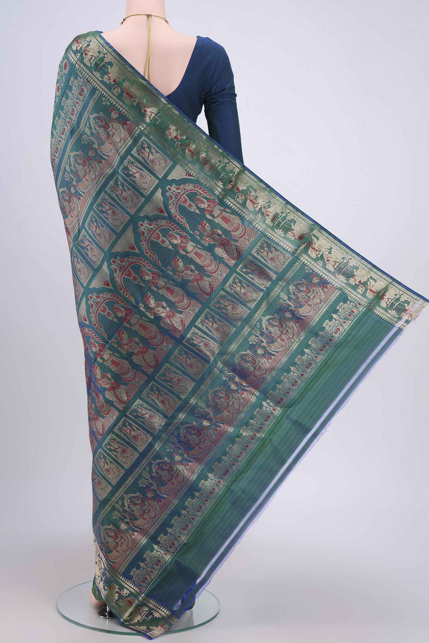 Flat view of Peacock Blue Dual Tone Baluchari Silk Saree with Zari Brocade on the body and Zari Border. 