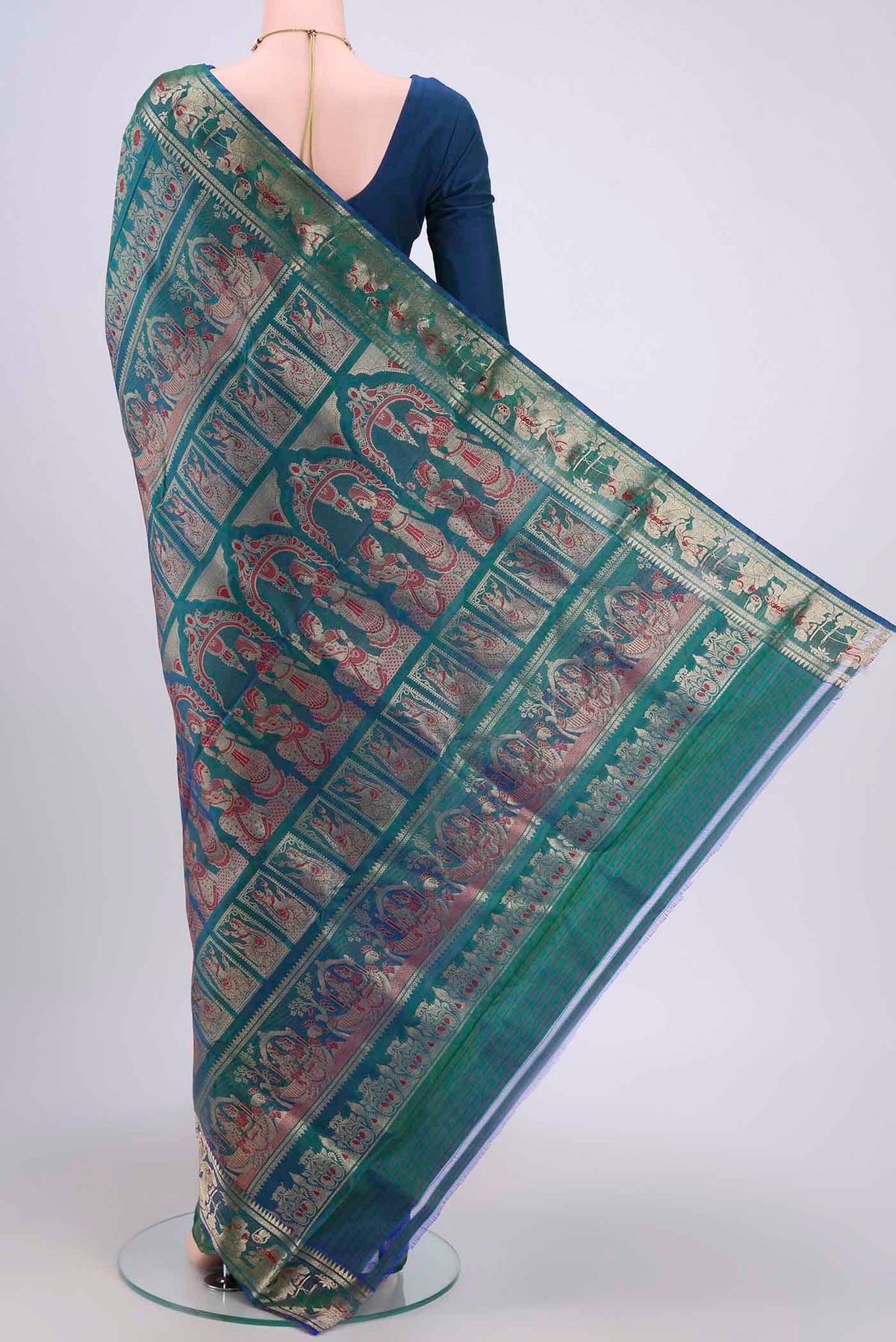 Flat view of Peacock Blue Dual Tone Baluchari Silk Saree with Zari Brocade on the body and Zari Border. 