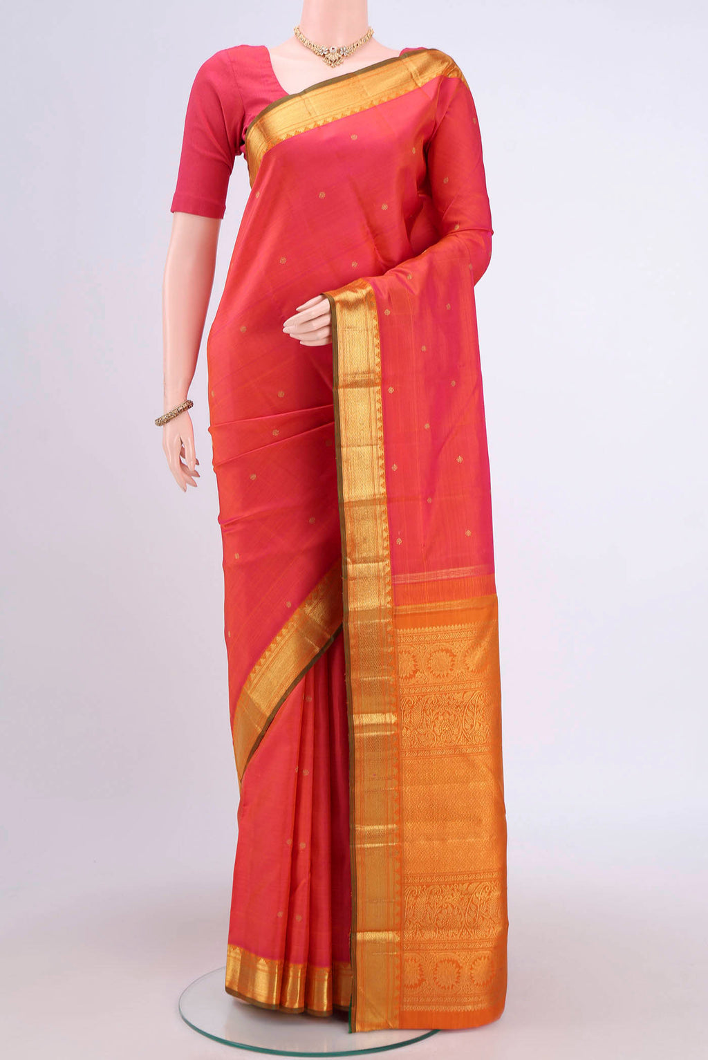 Pure Silk Pure Zari Orange with Pink Dual Tone Kanjivaram Saree with Zari Butta on the body and Zari Border.  displayed on a mannequin