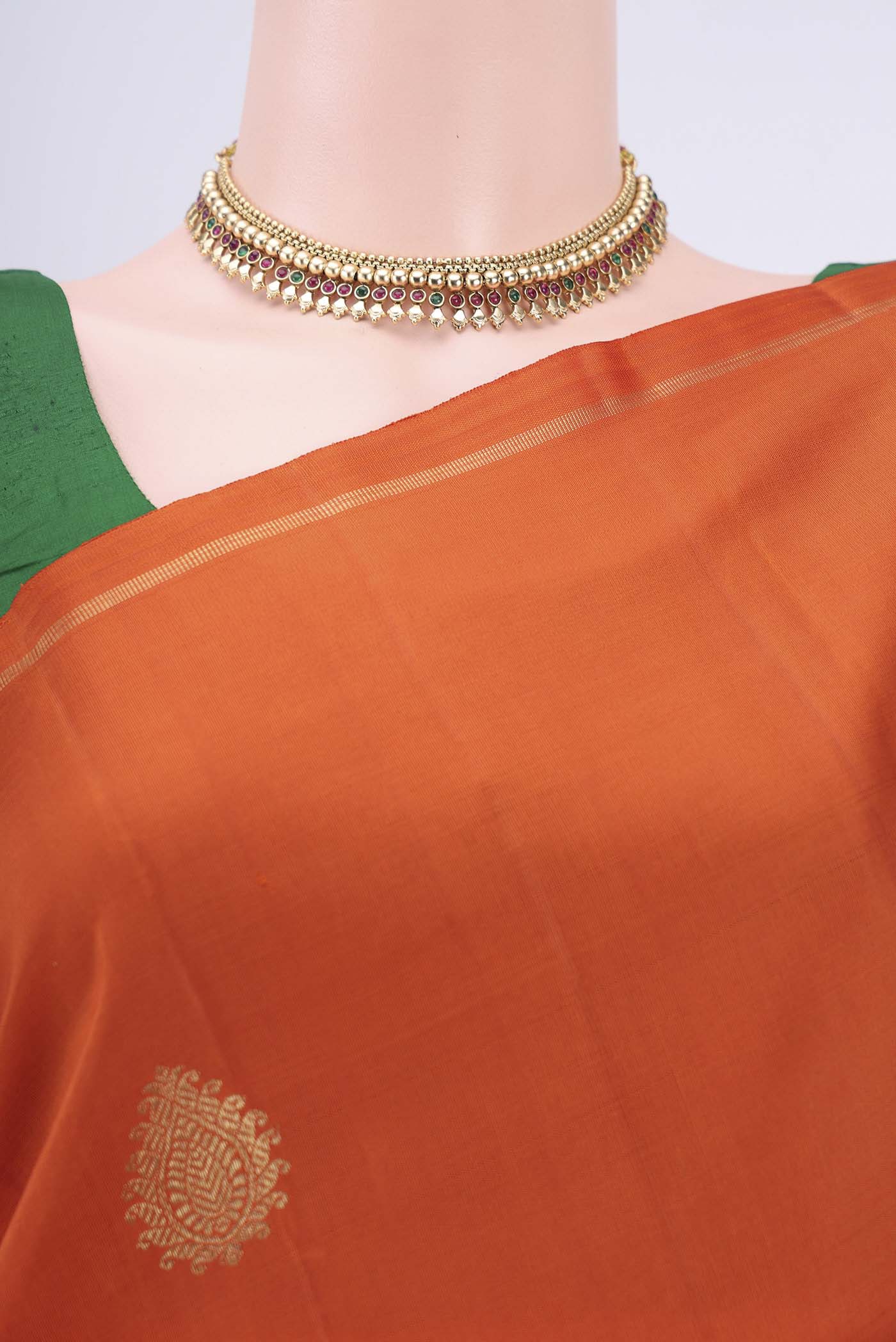 Border image of Pure Silk Pure Zari Rust Kanchipuram Saree with Zari Butta on the body and Thin Zari Line. 