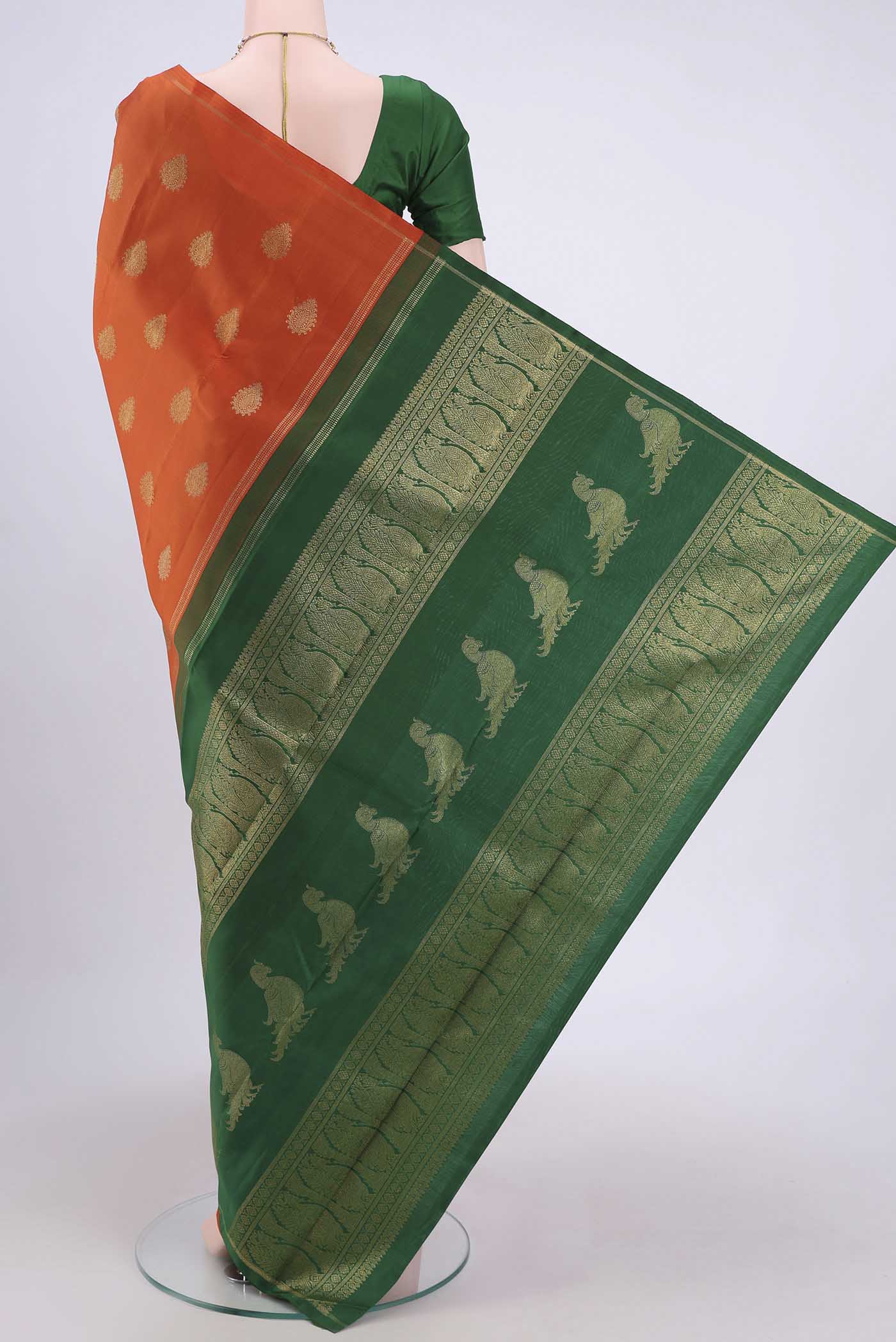 Flat view of Pure Silk Pure Zari Rust Kanchipuram Saree with Zari Butta on the body and Thin Zari Line. 