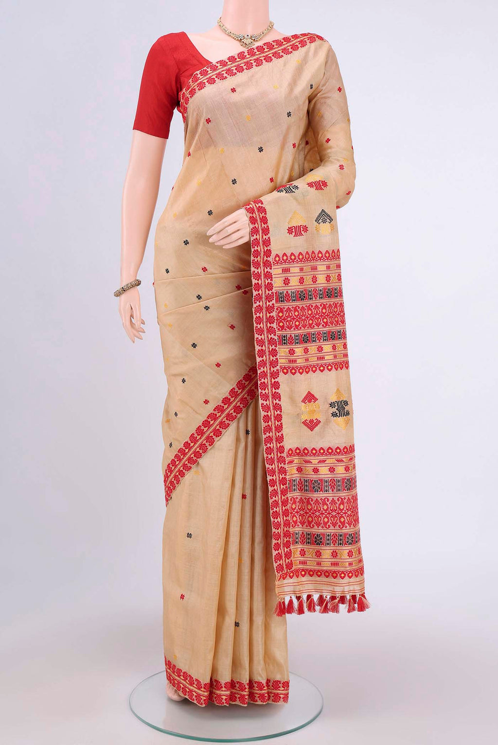 Dark Beige Assam Silk Saree with Thread Butta on the body and Thread Border.  displayed on a mannequin