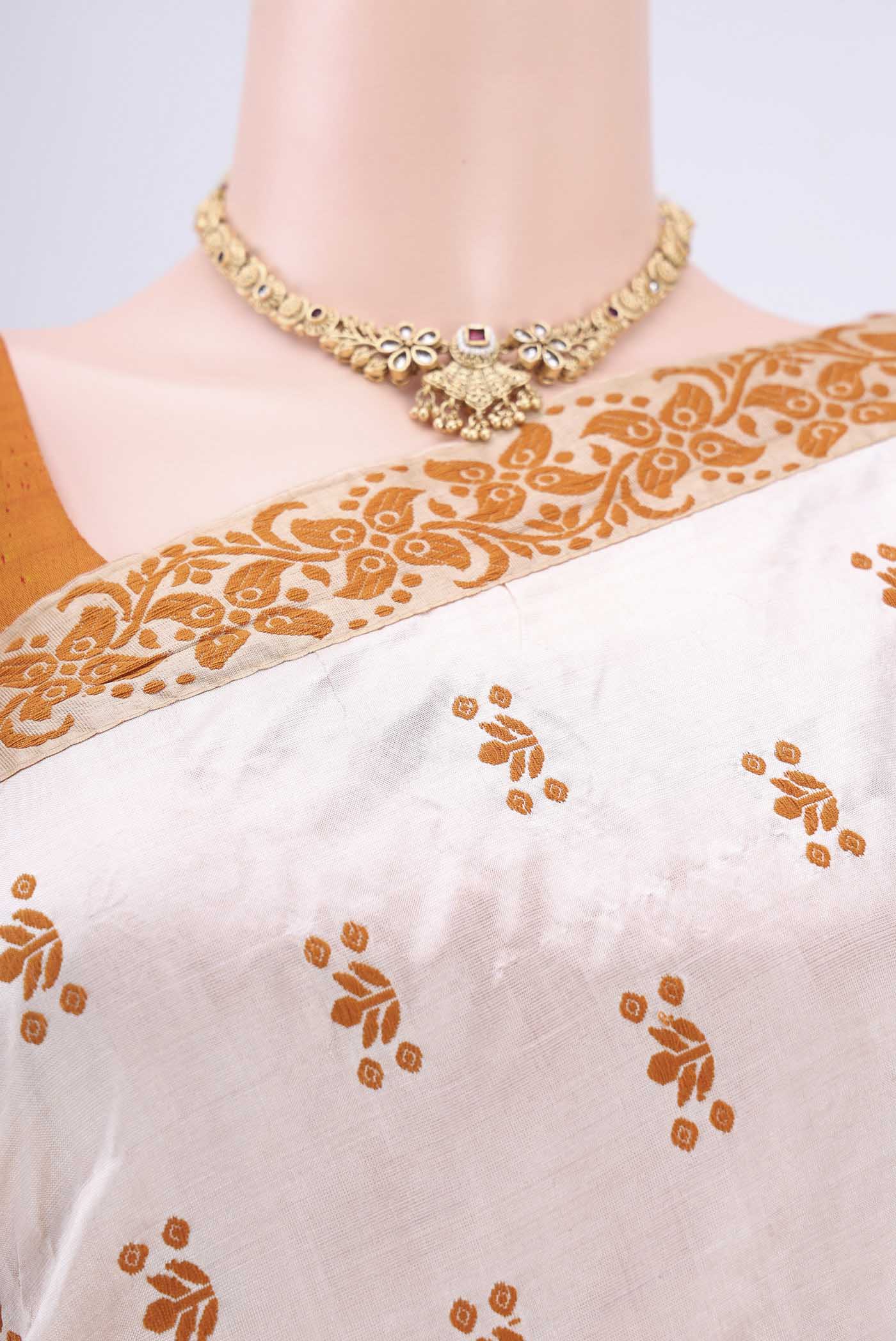 Border image of Cream Assam Silk Saree with Thread Butta on the body and Thread Border. 