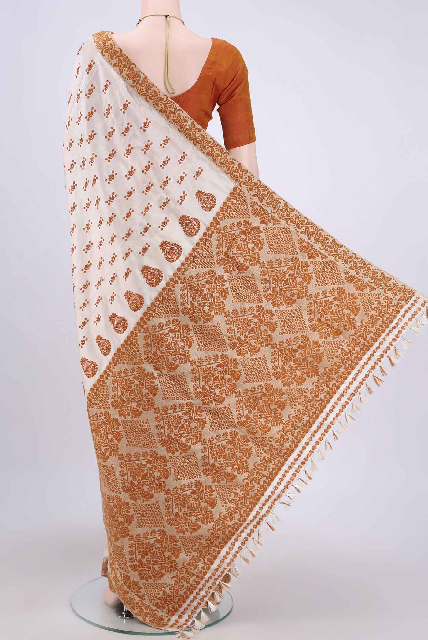 Flat view of Cream Assam Silk Saree with Thread Butta on the body and Thread Border. 