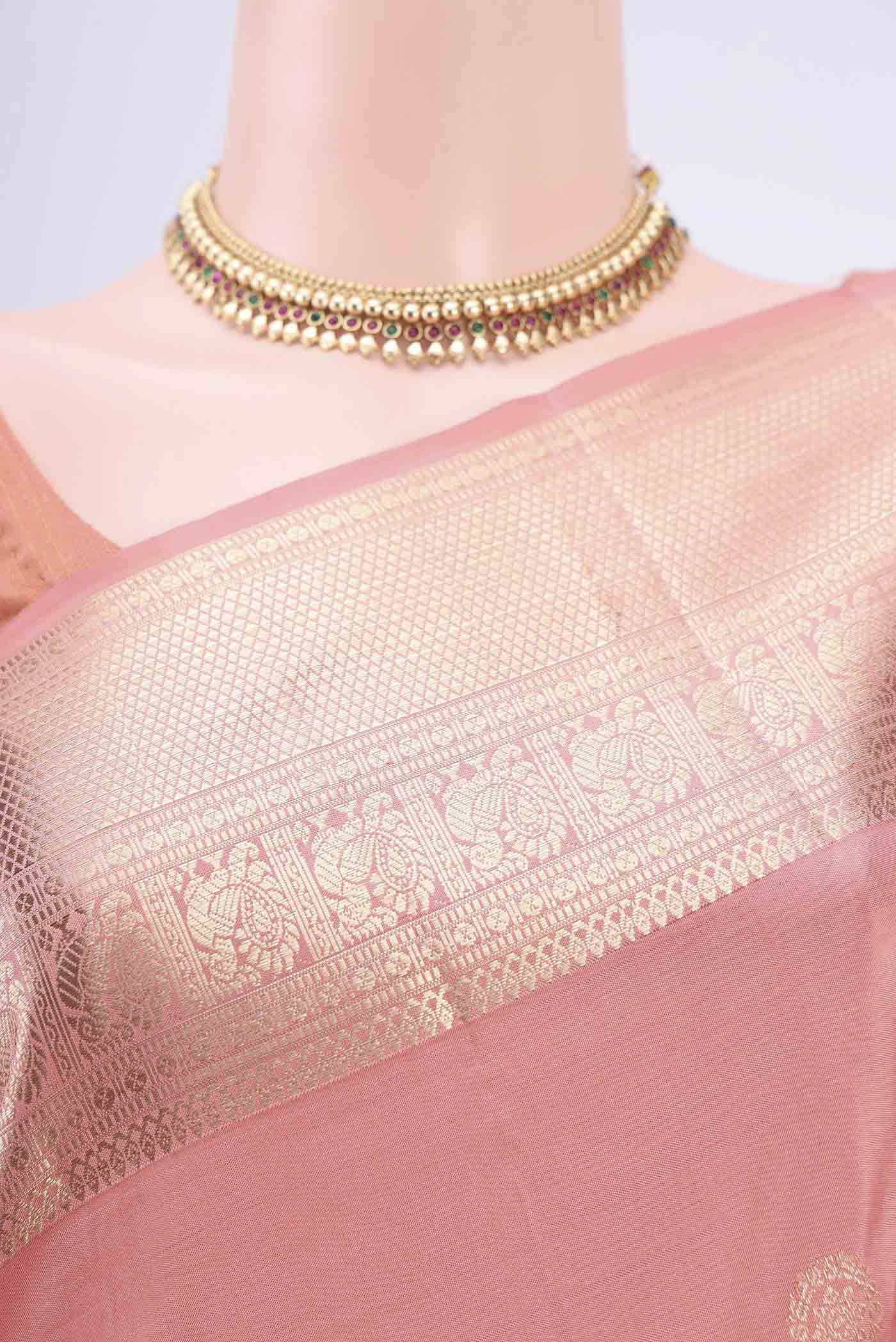Border image of Peach Kanjivaram Saree with Zari Butta on the body and Zari Border. 