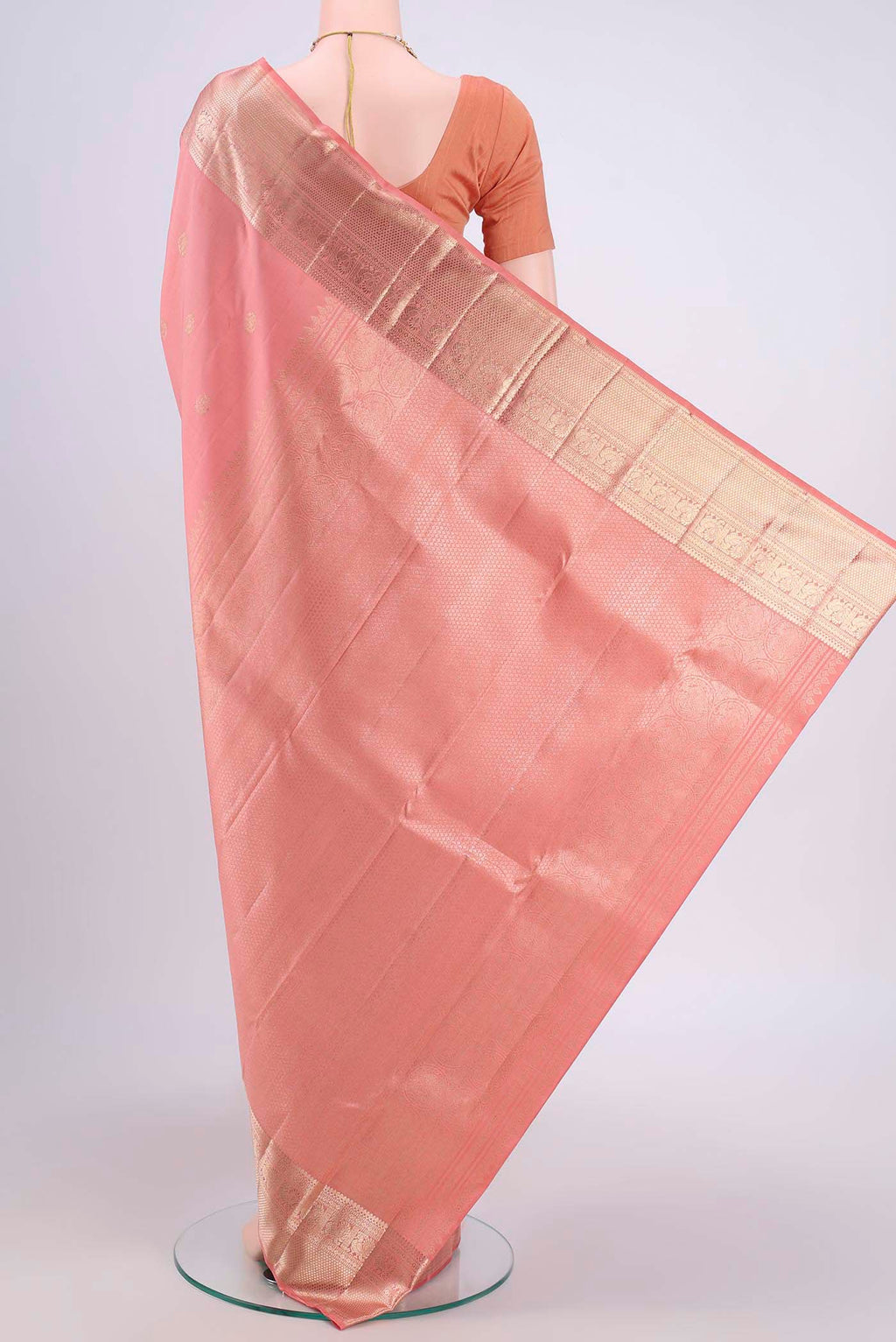 Flat view of Peach Kanjivaram Saree with Zari Butta on the body and Zari Border. 