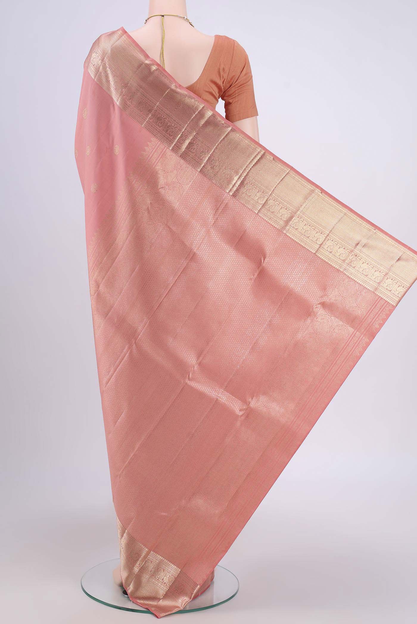 Flat view of Peach Kanjivaram Saree with Zari Butta on the body and Zari Border. 