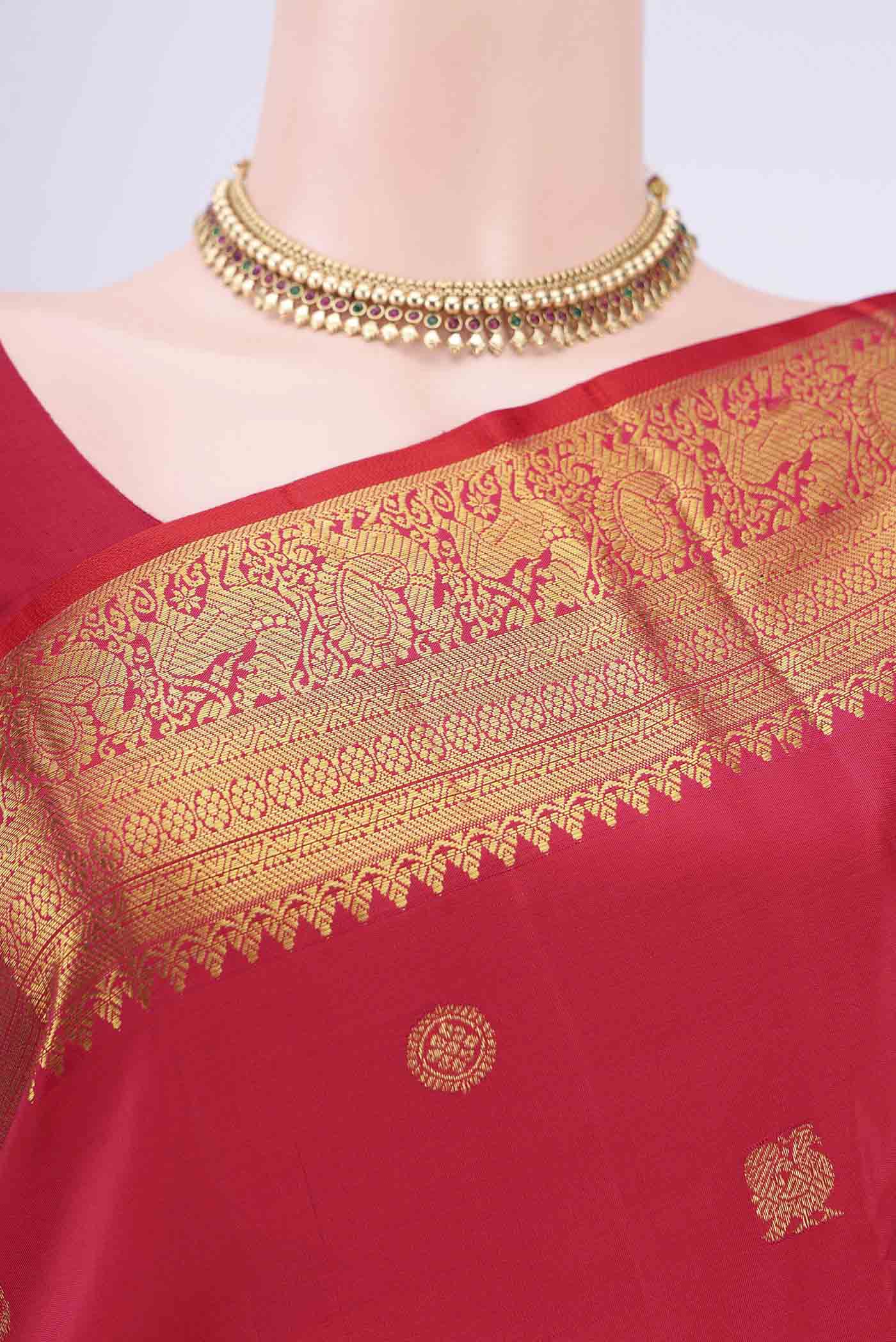 Border image of Red Kanjivaram Saree with Zari Butta on the body and Zari Border. 