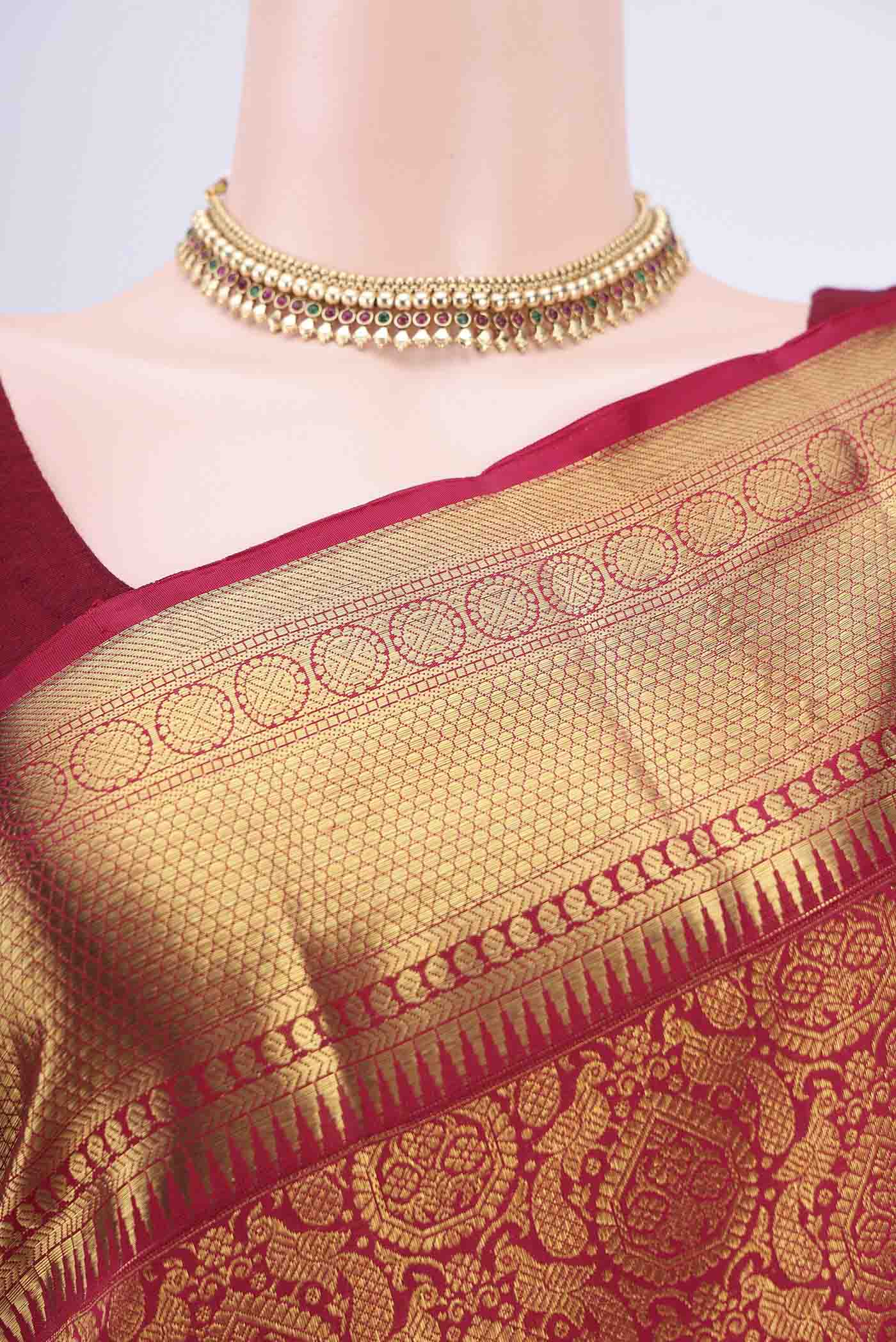 Border image of Maroon Kanchipuram Saree with Zari Brocade on the body and Zari Border. 