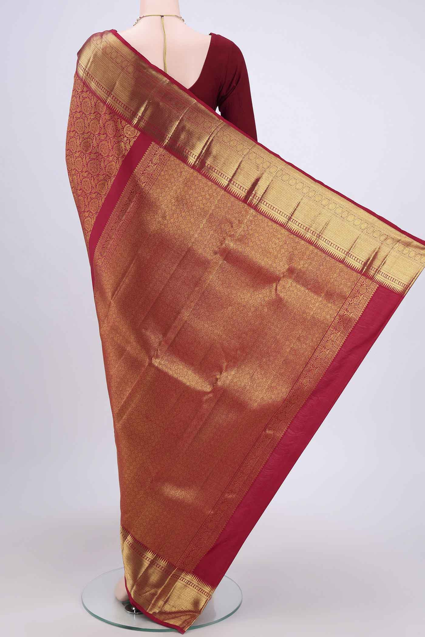 Flat view of Maroon Kanchipuram Saree with Zari Brocade on the body and Zari Border. 